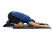 In a kneeling position, drop your buttocks toward your heels, rest your stomach on your thighs, and rest your forehead on the floor. Your arms should be above your head and relaxed.