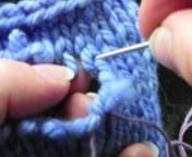 http://knitfreedom.comnnTo mend a hole in knitting, first clean up the edges as best you can by trimming ends that are sticking out. Use a crochet hook to re-knit any stitches that have fallen out.nnUsing a tapestry needle, weave a thin thread through the stitches vertically to create some structure. Then, cut as many pieces of yarn as you have rows missing.nnWeave one end of yarn horizontally through the thin threads. Then use a crochet hook to re-knit that row of stitches. Repeat for as many r