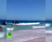 &#60;br/&#62;COURTESY: CARLOS SANZ &#60;br/&#62;Tourists and sun worshipers lounging on a Spanish beach were stunned when an inflatable dingy full of migrants landed on the shore.