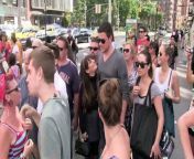 Cory Monteith and Lea Michele filming episode of GLEE, walking through a very crowded block to get to their waiting SUV.