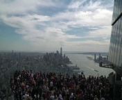 A timelapse shows the sky darkening over New York City as people gather on the observation deck of skyscraper the Edge, during the solar eclipse.