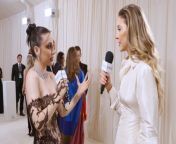 Madelyn Cline talks with Emma Chamberlain at the 2024 Met Gala about her Tommy Hilfiger dress, her tiny clutch, and maybe dancing together by the end of the Met night.
