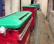 An Abergavenny alleyway crowded with bins